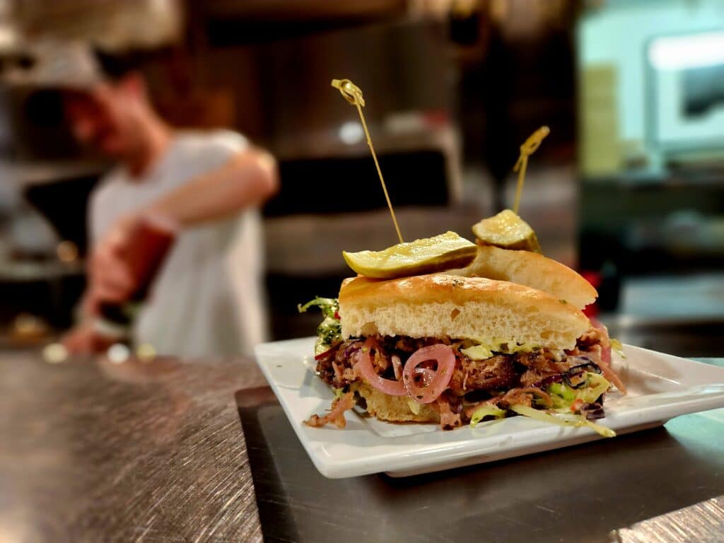 our pork shoulder sandwich, that curly pickled onion sticking out is just so darn cute!